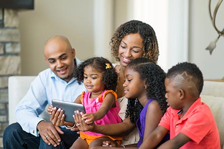 family looking at tablet