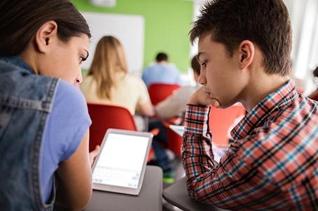 Two students looking at tablet