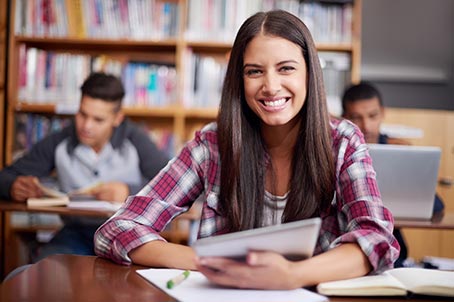 student smiling at desk