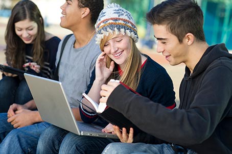 teenagers looking at book